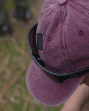a man wearing the Wofte vintage patch baseball cap walking around a big carp fishing lake in Essex